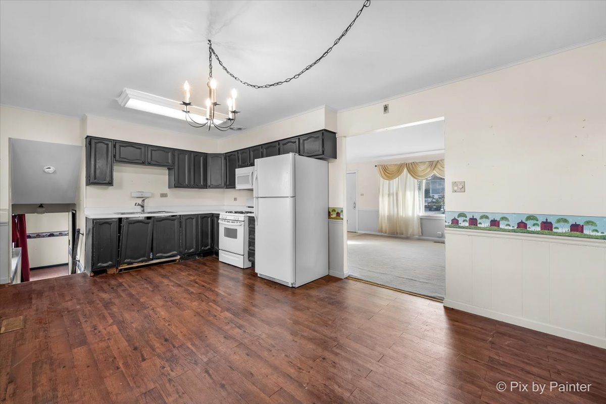 500 Colgate Court Hoffman Estates, IL 60169 - Photo 3 of 28 a view of a kitchen with wooden floor and a refrigerator