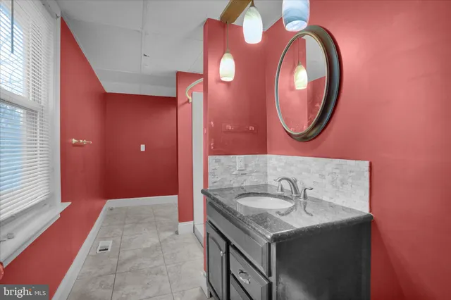 a bathroom with a sink and a mirror