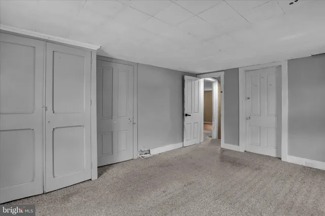 a view of an empty room and closet area