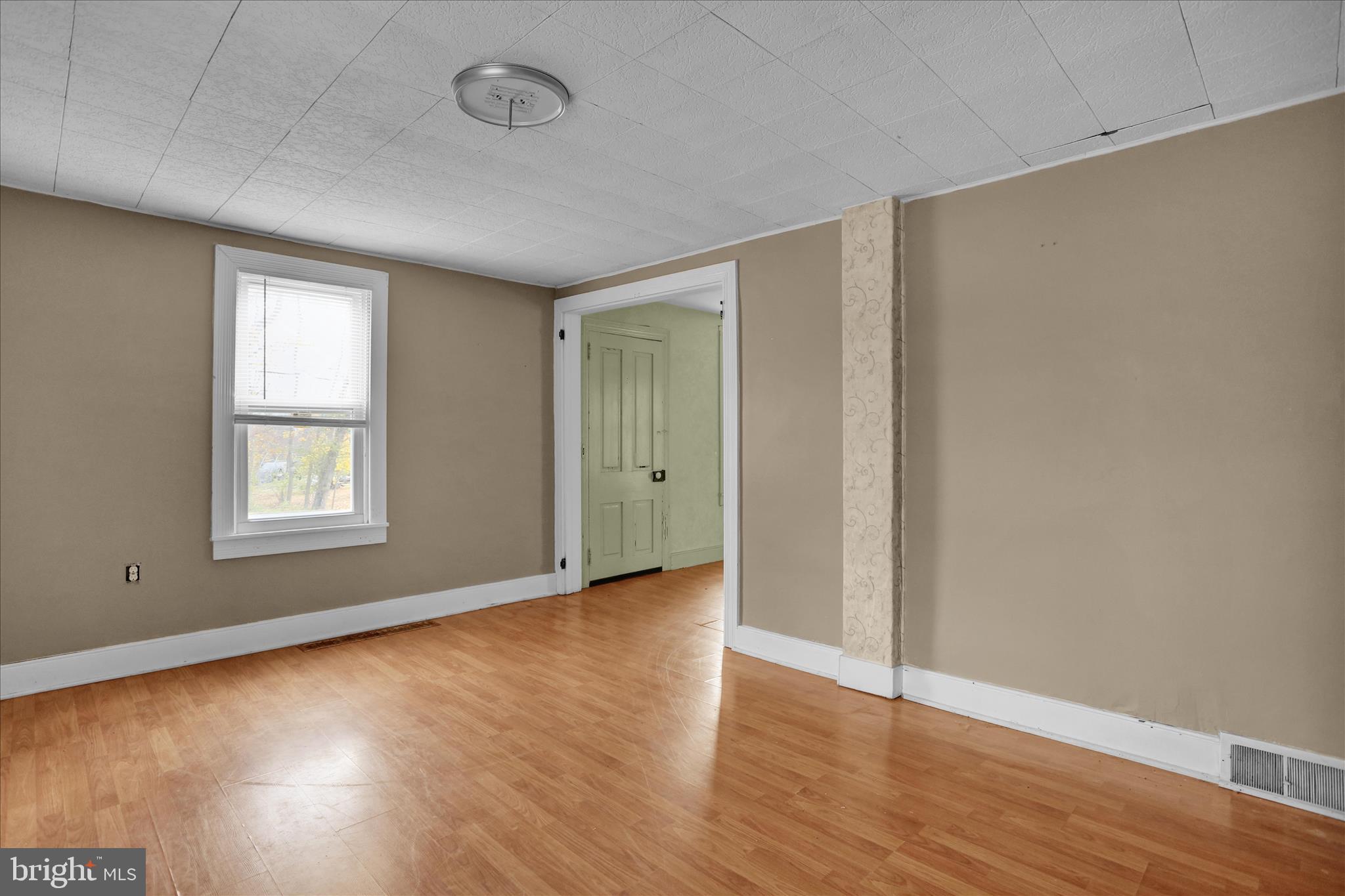 320 South Baumstown Road Birdsboro, PA 19508 - Photo 3 of 43 an empty room with wooden floor and windows