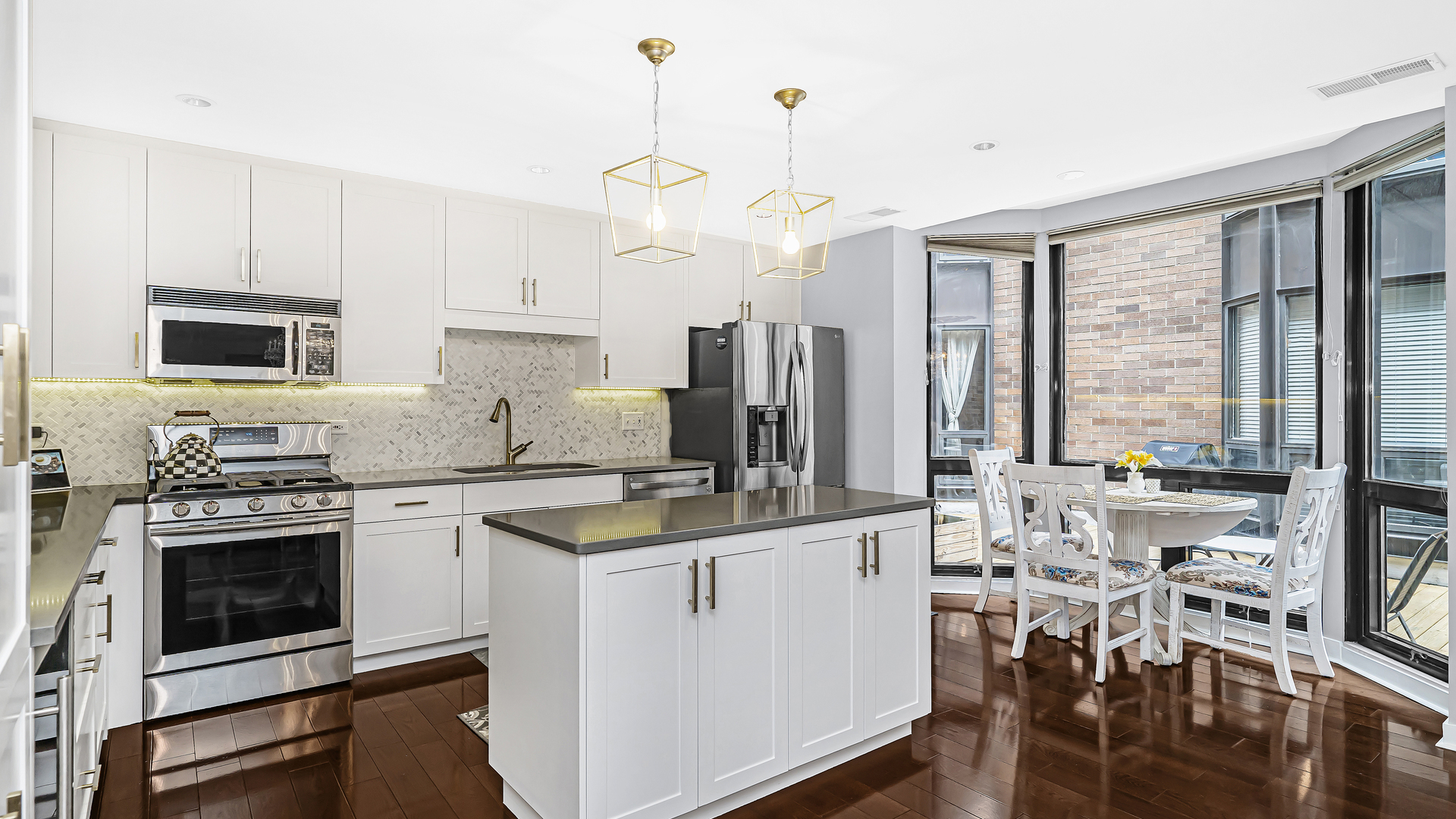 222 South Racine Avenue, Unit 404 Chicago, IL 60607 - Photo 13 of 36 a kitchen with stainless steel appliances granite countertop a stove a sink a microwave a refrigerator a stove and white cabinets