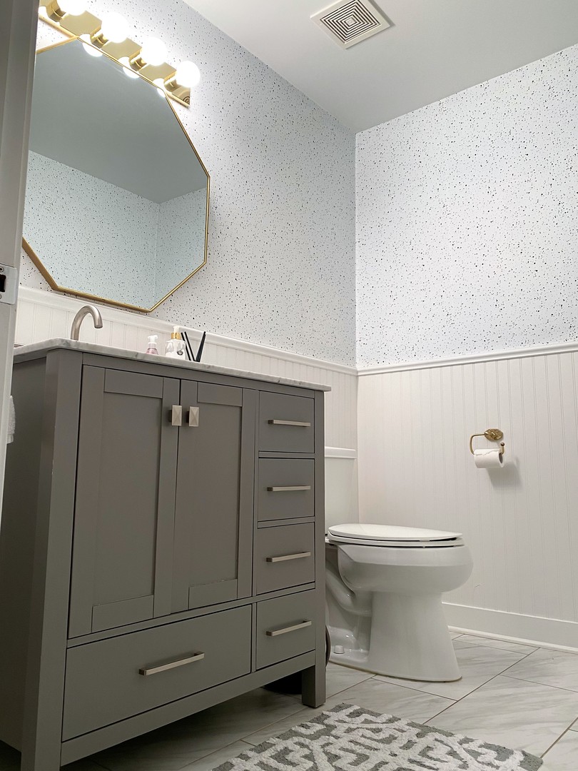 222 South Racine Avenue, Unit 404 Chicago, IL 60607 - Photo 5 of 36 a bathroom with a toilet and a mirror