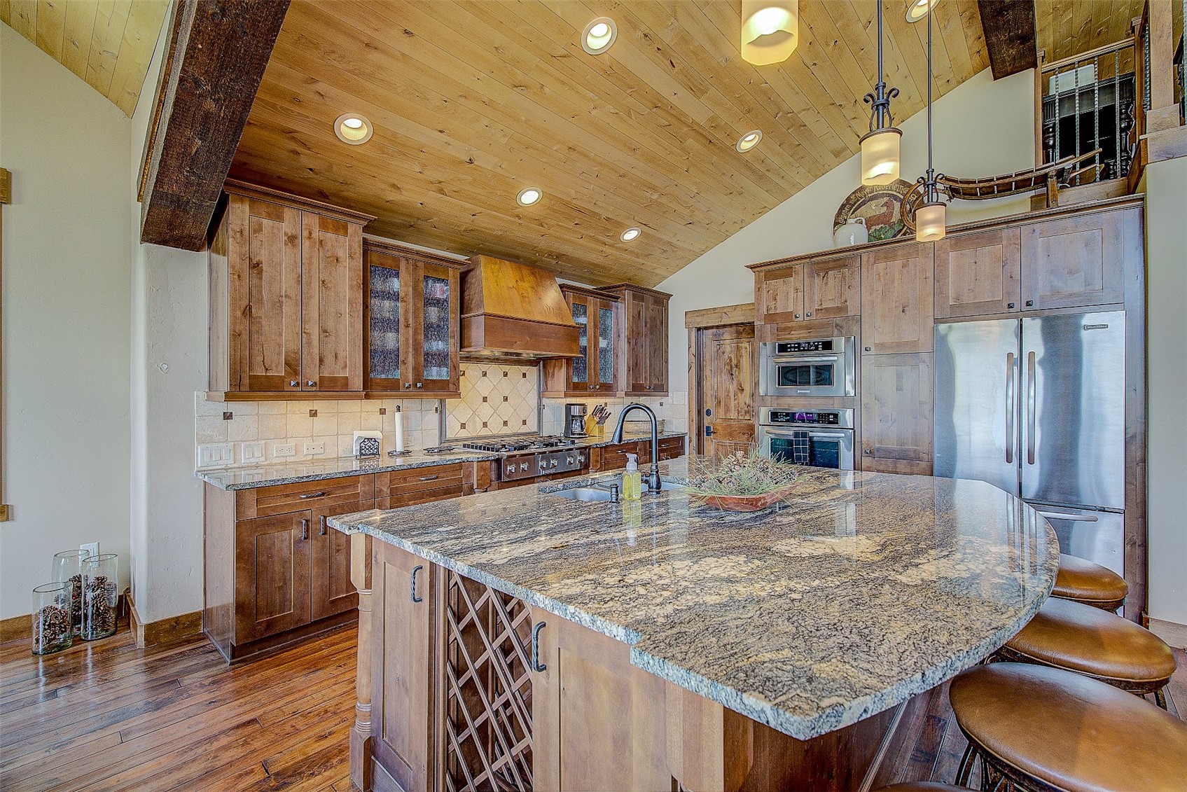 59 Club House Road, Unit C Breckenridge, CO 80424 - Photo 32 of 50 Kitchen with glass insert cabinets, tasteful backsplash, dark stone countertops, a breakfast bar area, and wood ceiling