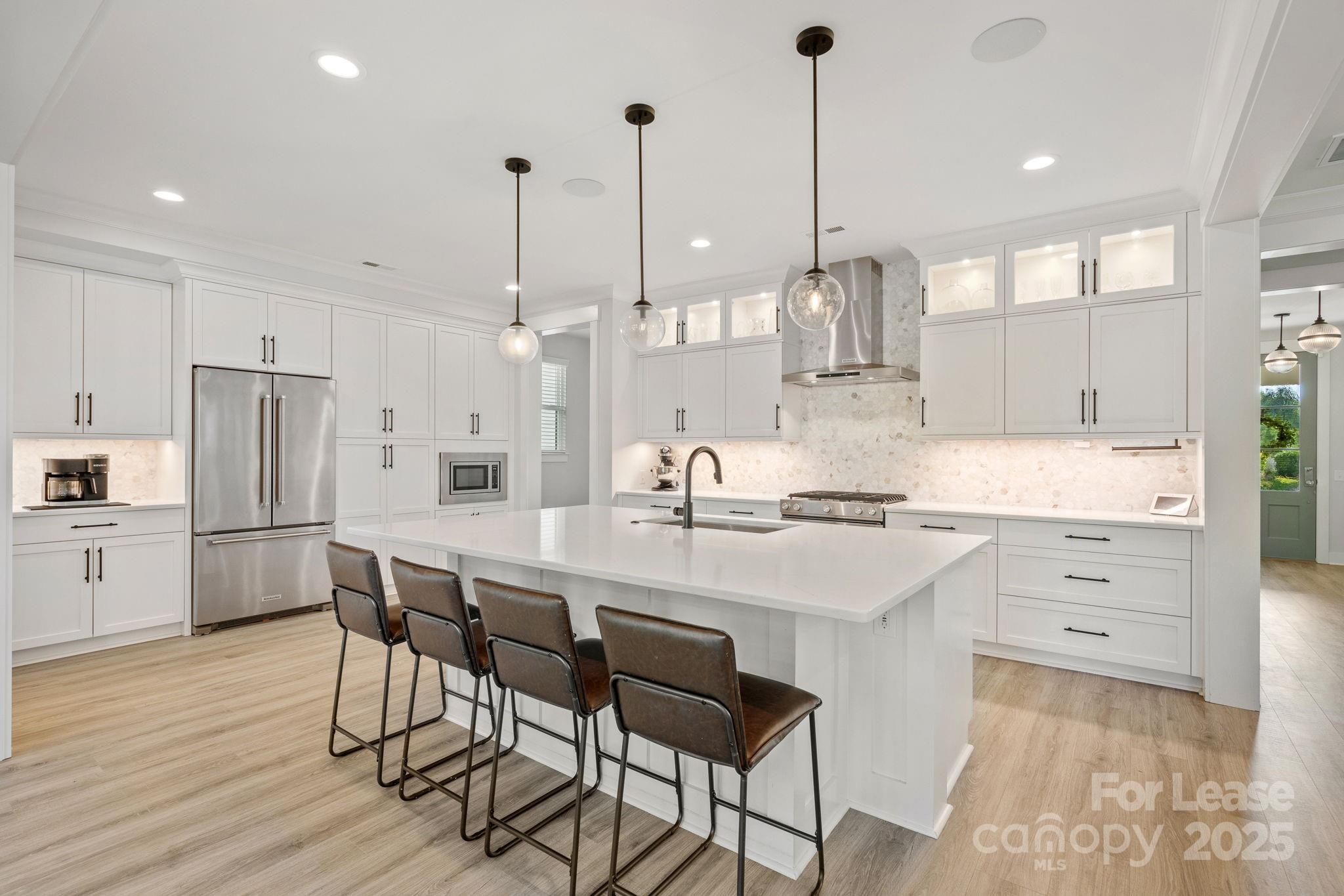 12012 Huntson Reserve Road Huntersville, NC 28078 - Photo 11 of 36 a kitchen with stainless steel appliances kitchen island a refrigerator and a stove