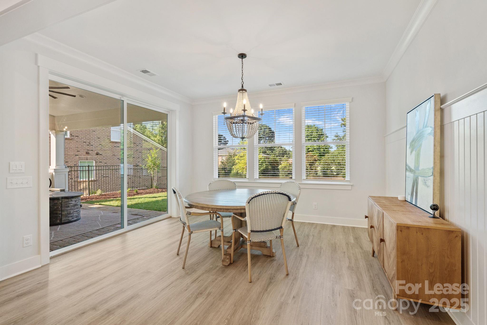 12012 Huntson Reserve Road Huntersville, NC 28078 - Photo 14 of 36 a dining room with furniture a chandelier and wooden floor
