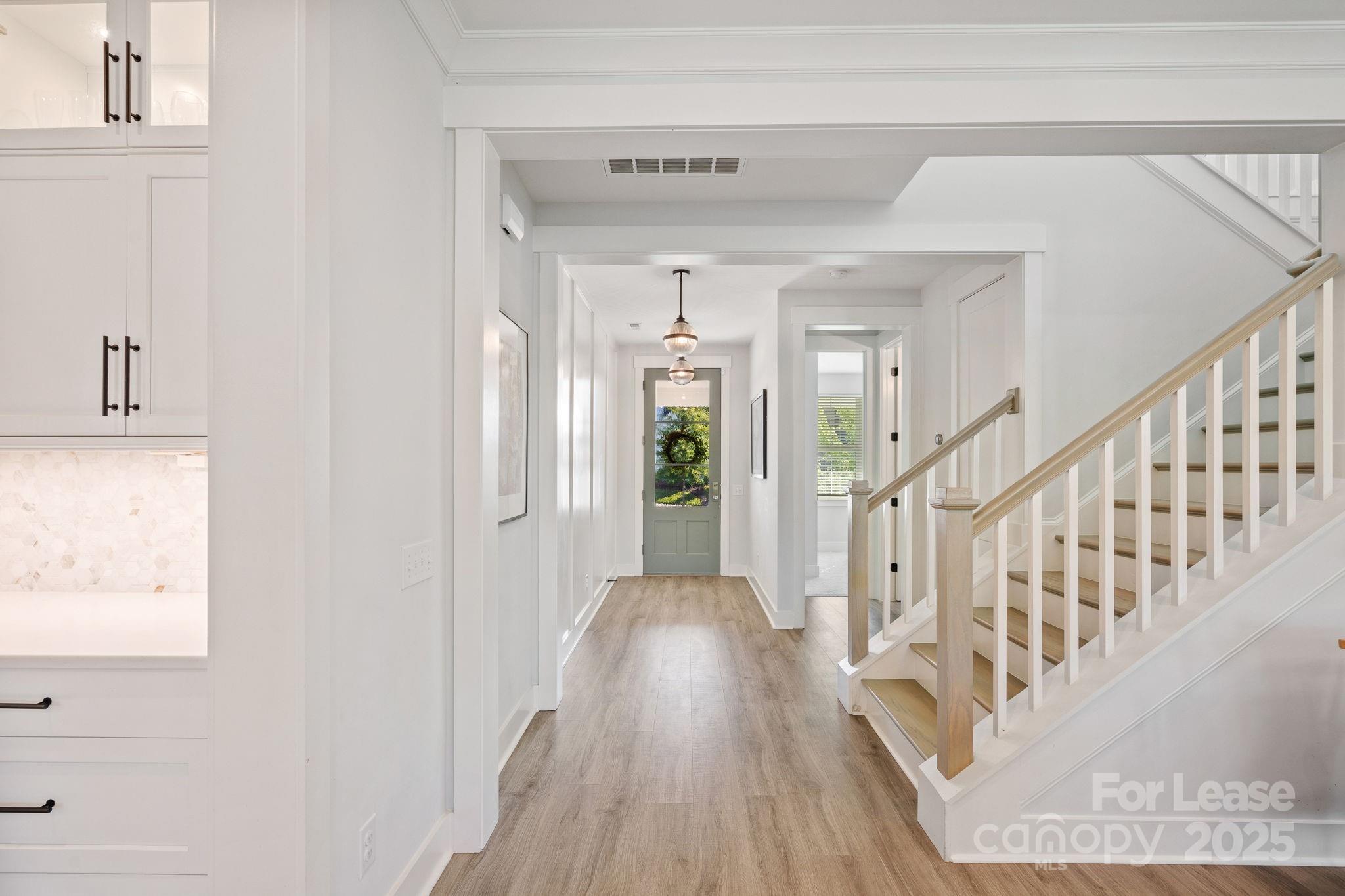 12012 Huntson Reserve Road Huntersville, NC 28078 - Photo 17 of 36 a view of a hallway with wooden floor and staircase