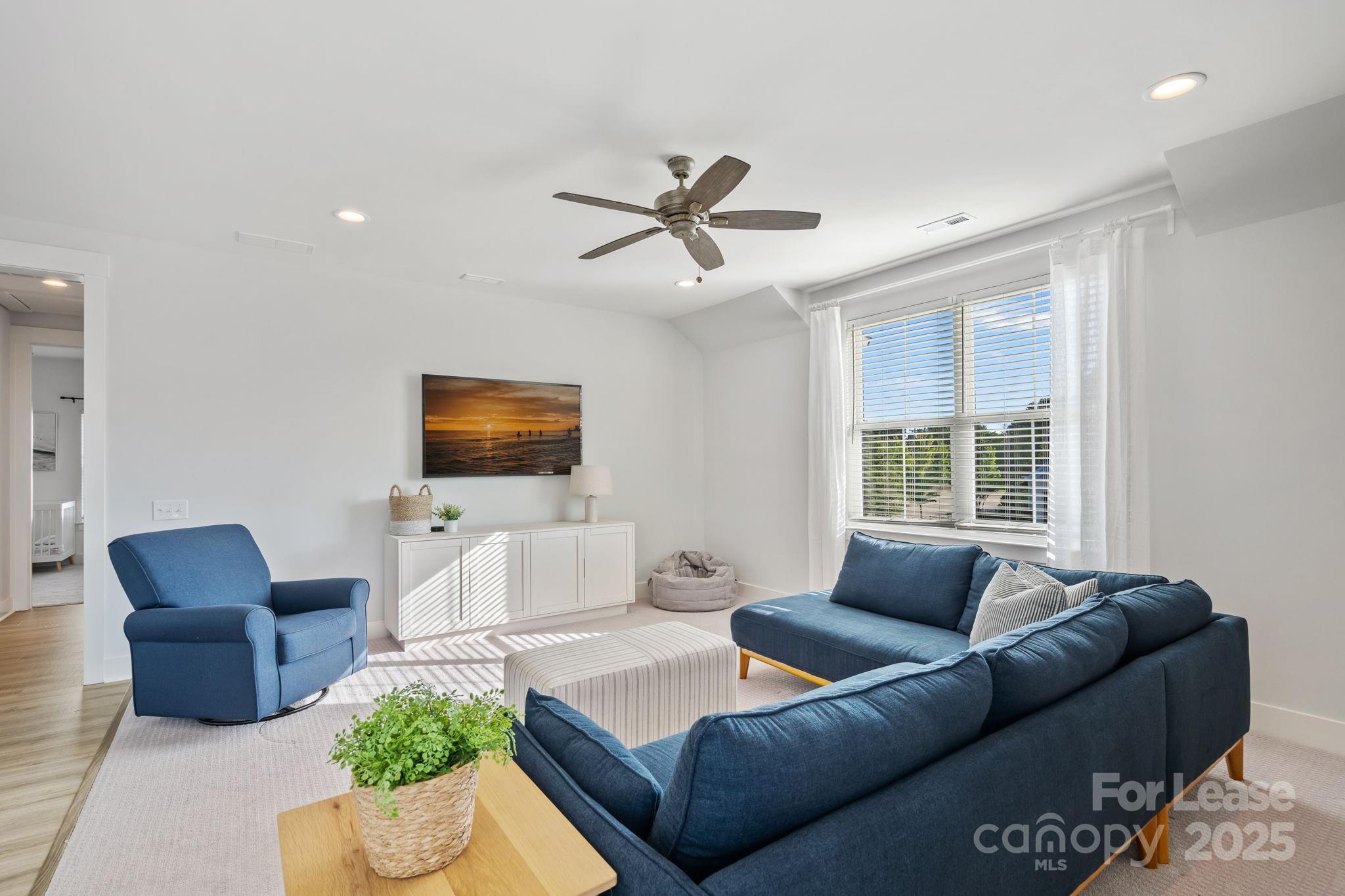 12012 Huntson Reserve Road Huntersville, NC 28078 - Photo 19 of 36 a living room with furniture and a flat screen tv