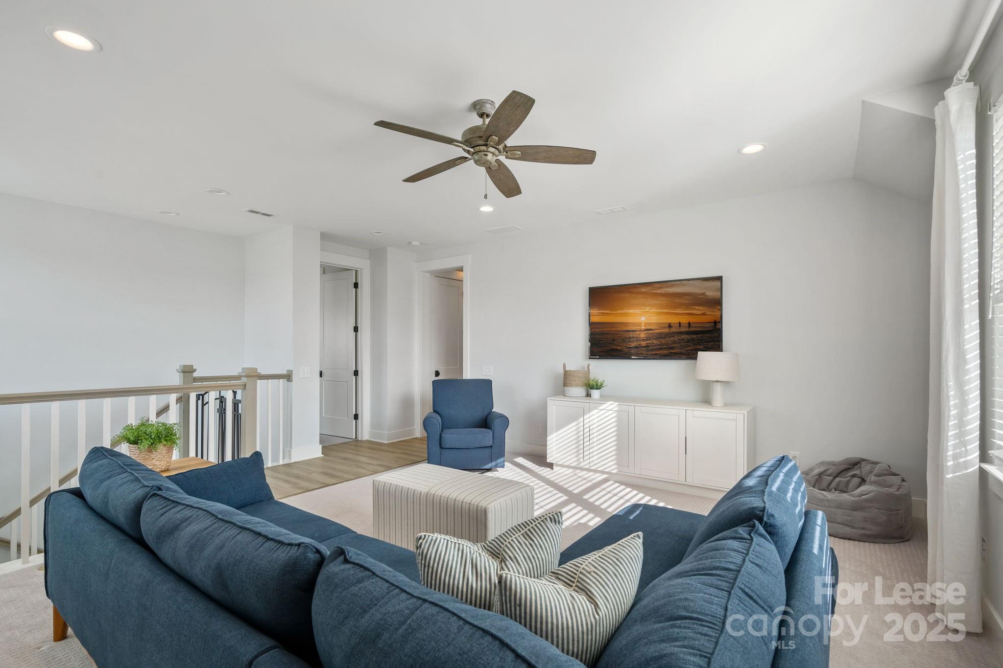 12012 Huntson Reserve Road Huntersville, NC 28078 - Photo 20 of 36 a living room with a couch and a flat screen tv