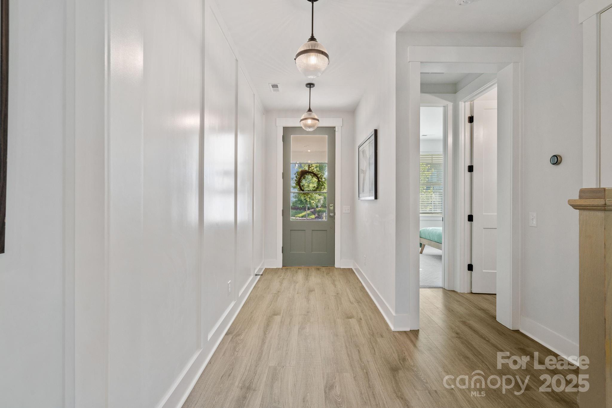 12012 Huntson Reserve Road Huntersville, NC 28078 - Photo 3 of 36 a view of a hallway with wooden floor and staircase