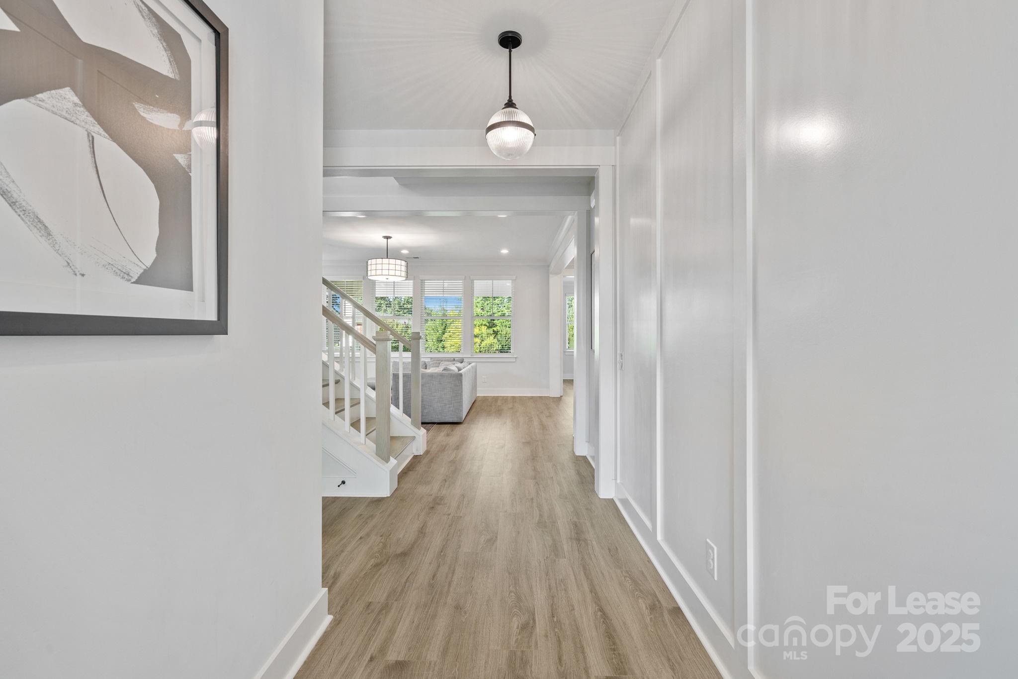 12012 Huntson Reserve Road Huntersville, NC 28078 - Photo 4 of 36 a view of a hallway to a livingroom with wooden floor