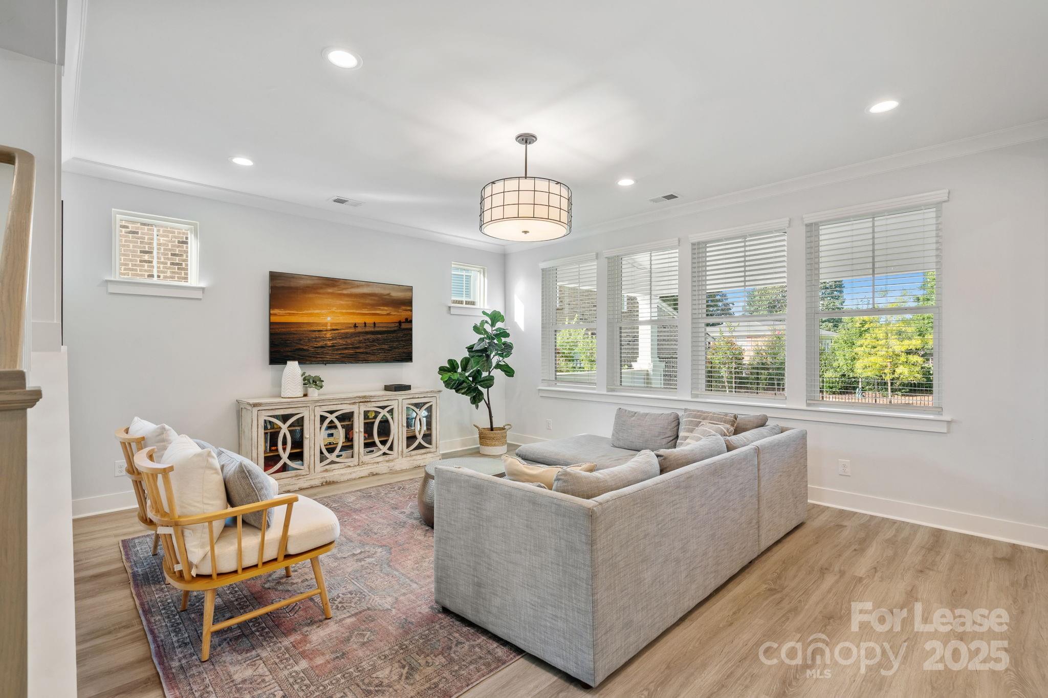 12012 Huntson Reserve Road Huntersville, NC 28078 - Photo 7 of 36 a living room with furniture and a flat screen tv
