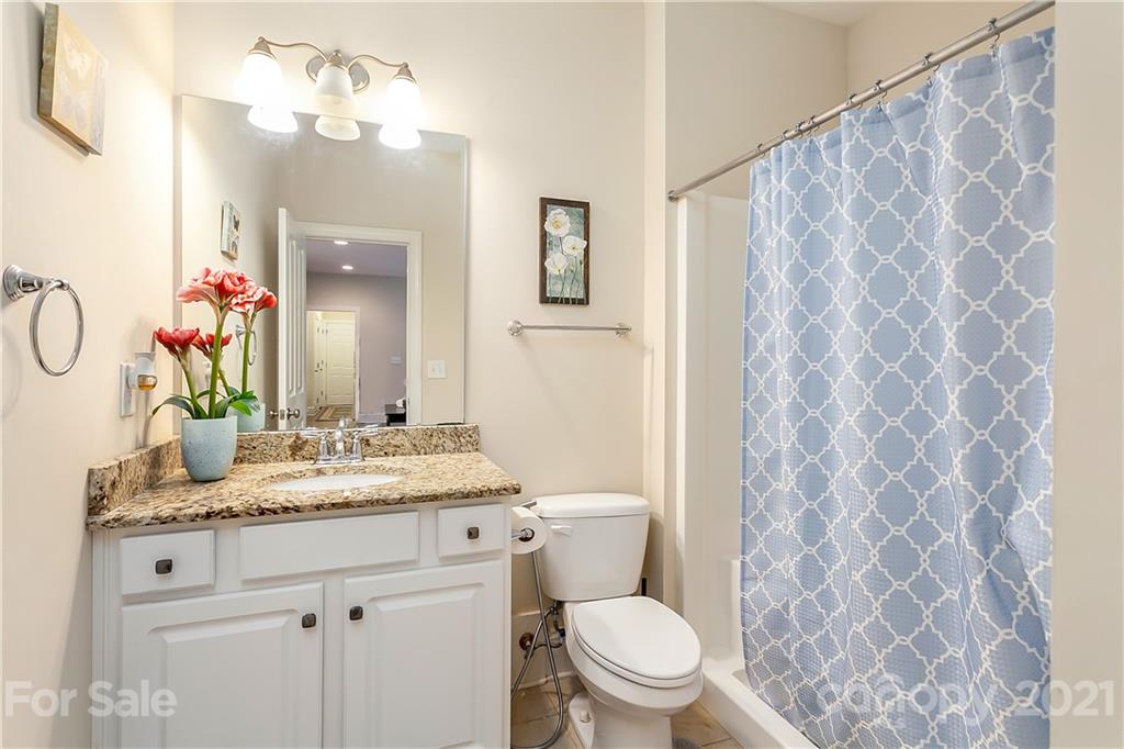 2522 Walker Road Matthews, NC 28105 - Photo 11 of 37 a bathroom with a granite countertop sink a toilet and a mirror