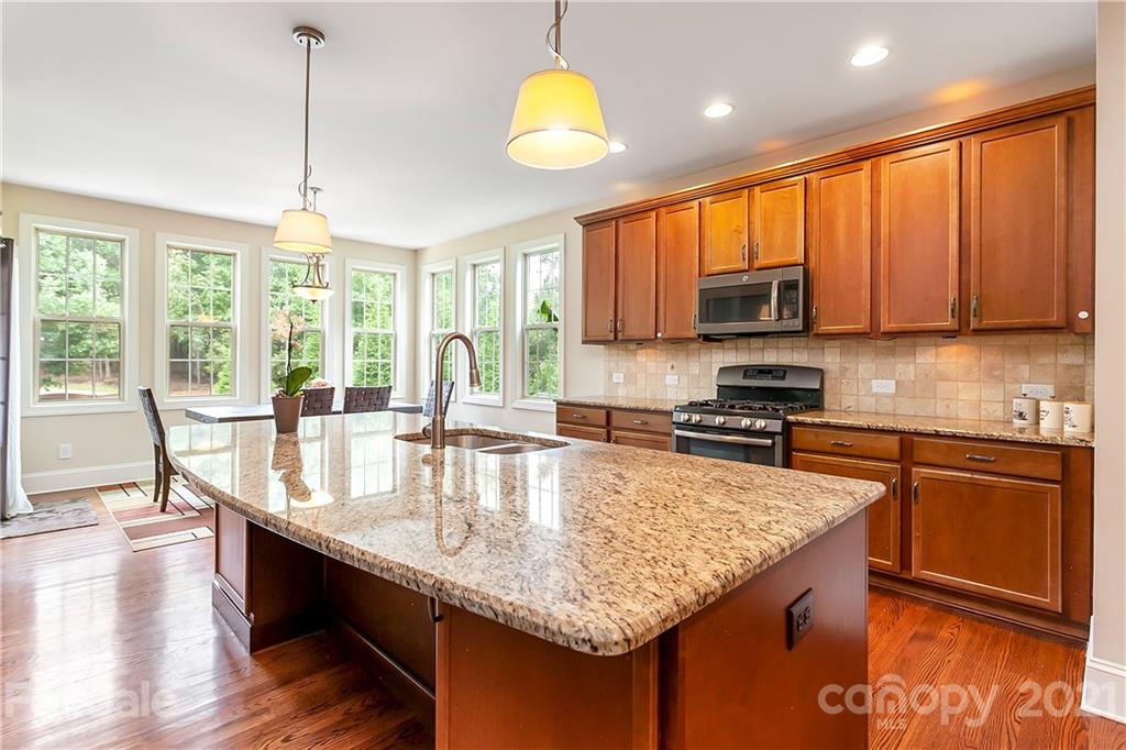 2522 Walker Road Matthews, NC 28105 - Photo 15 of 37 a kitchen with stainless steel appliances granite countertop a stove sink and cabinets