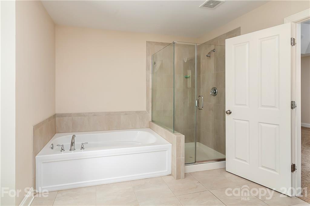 2522 Walker Road Matthews, NC 28105 - Photo 18 of 37 a bathroom with a bathtub and a shower