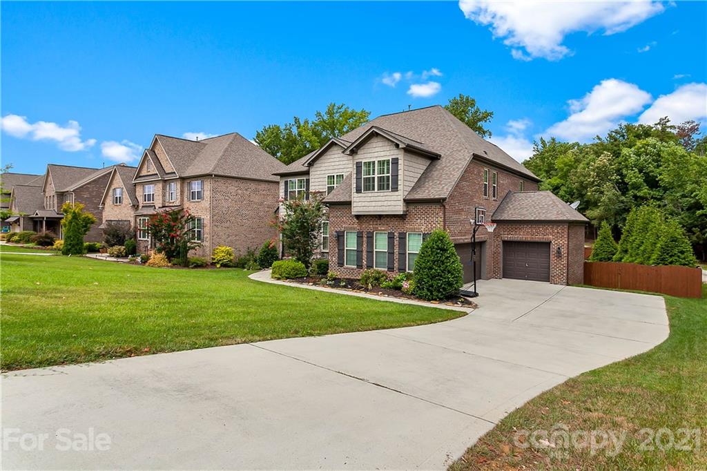 2522 Walker Road Matthews, NC 28105 - Photo 3 of 37 a front view of a house with a garden and yard