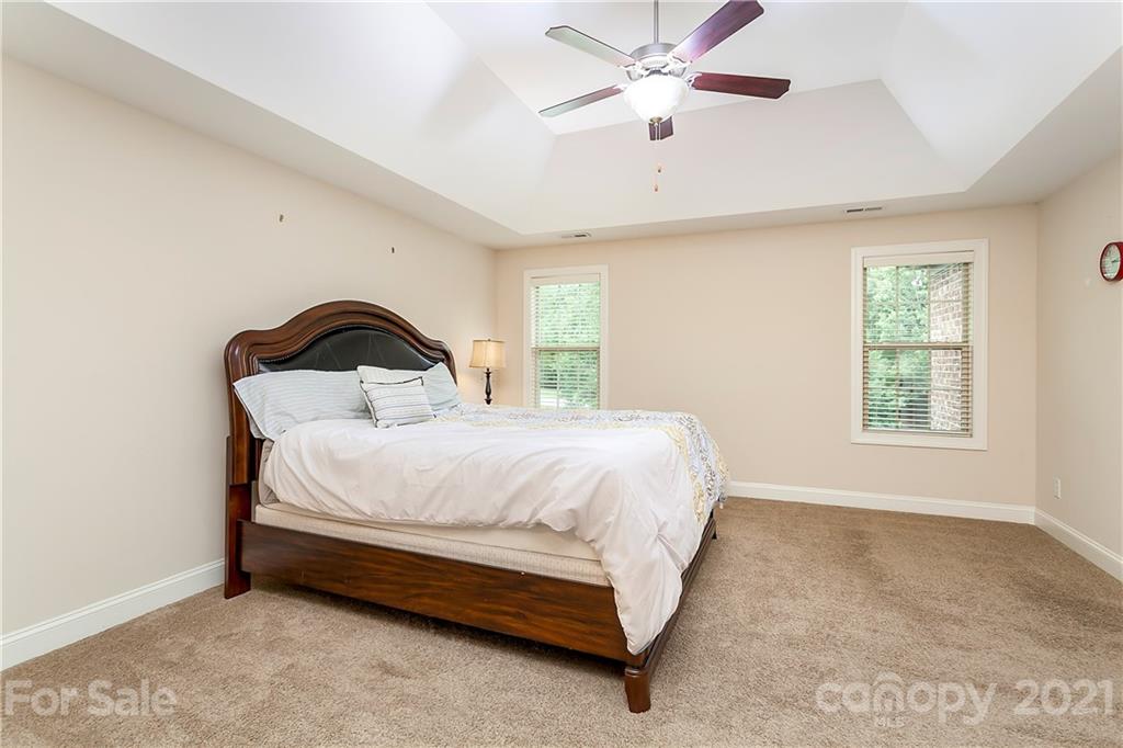 2522 Walker Road Matthews, NC 28105 - Photo 21 of 37 a bedroom with a bed and a ceiling fan