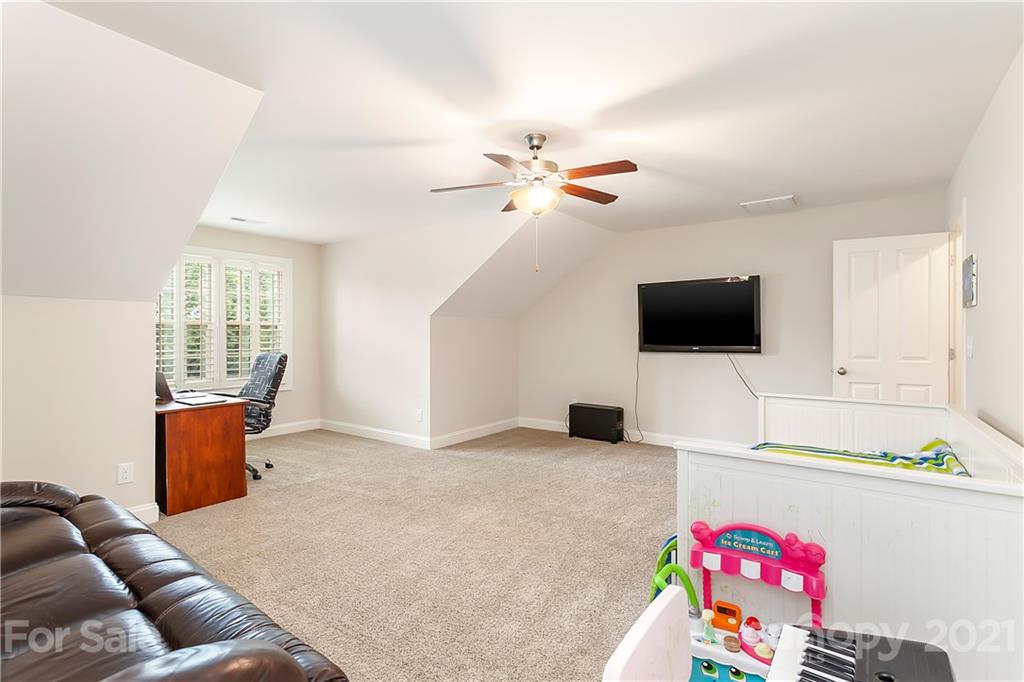 2522 Walker Road Matthews, NC 28105 - Photo 24 of 37 a living room with furniture and a flat screen tv