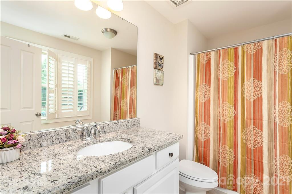2522 Walker Road Matthews, NC 28105 - Photo 27 of 37 a bathroom with a granite countertop sink and a mirror