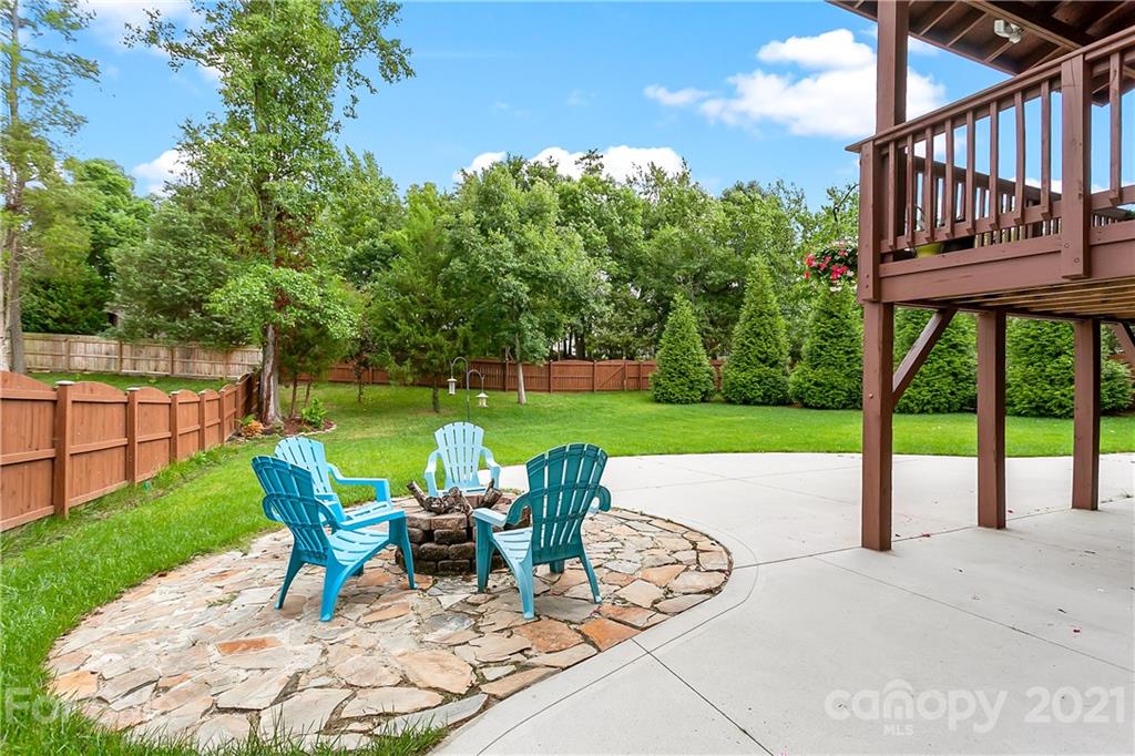 2522 Walker Road Matthews, NC 28105 - Photo 34 of 37 a view of yard with seating area and trees in the background