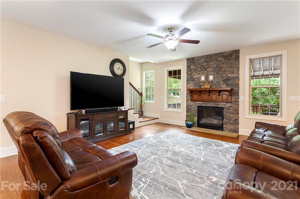 2522 Walker Road Matthews, NC 28105 - Photo 9 of 37 a living room with furniture a fireplace and a flat screen tv