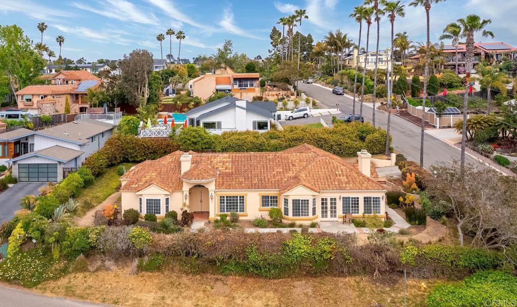 an aerial view of residential houses with yard