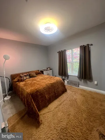 a spacious bedroom with a bed and a window