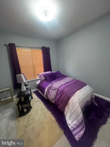 a bedroom with a bed and a mirror