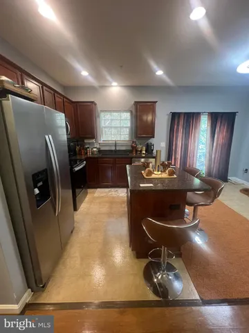 a room with furniture a rug and kitchen view