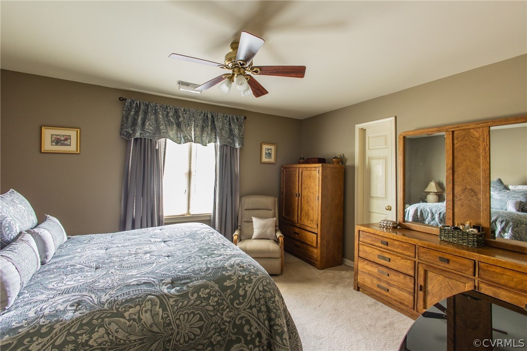 5169 Hackney Road North Chesterfield, VA 23234 - Photo 17 of 29 a bedroom with a bed dresser and a large mirror