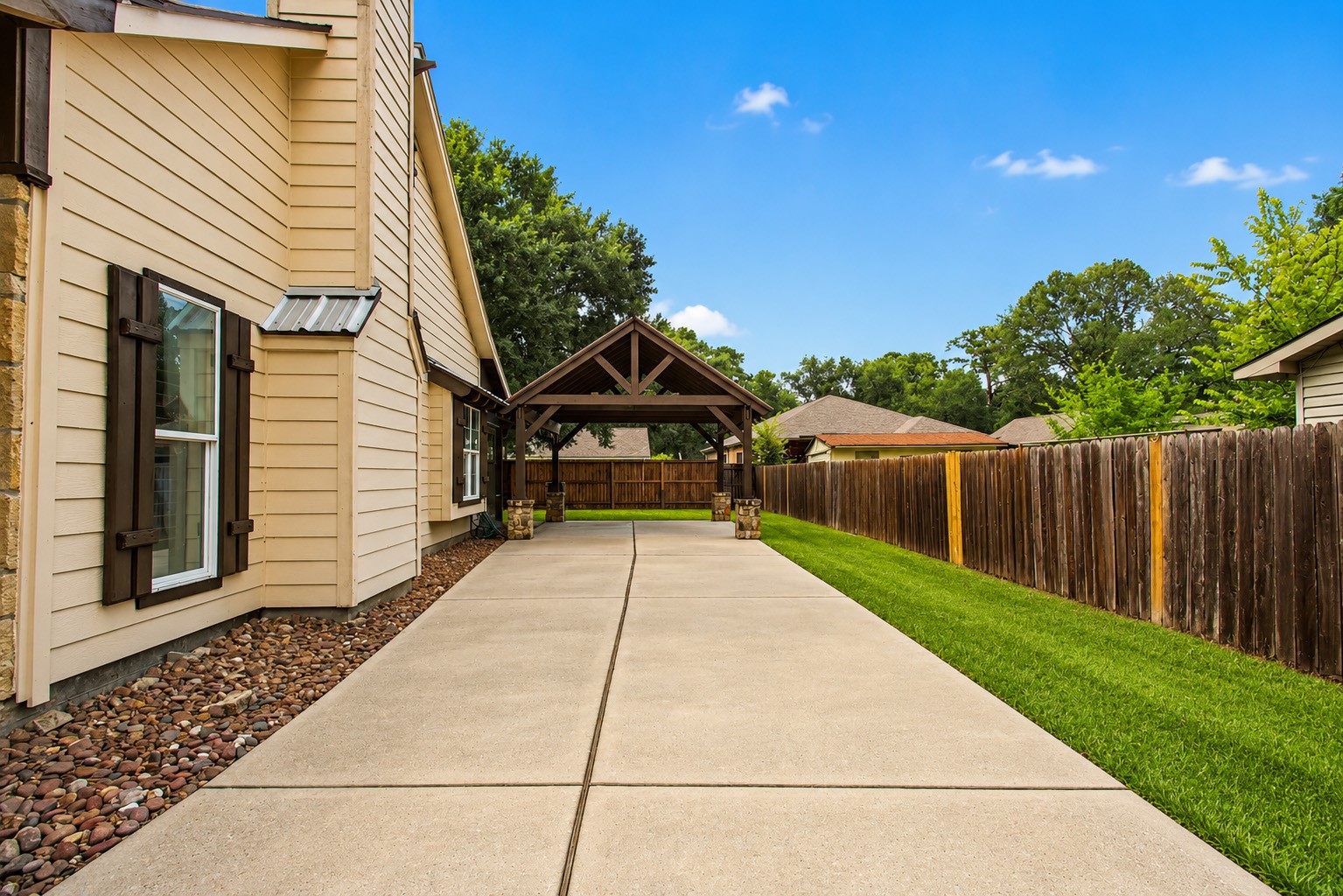 312 Springwood Drive Conroe, TX 77385 - Photo 5 of 50 Enjoy the luxury of parking under the custom carport with private entry to the back of the home.