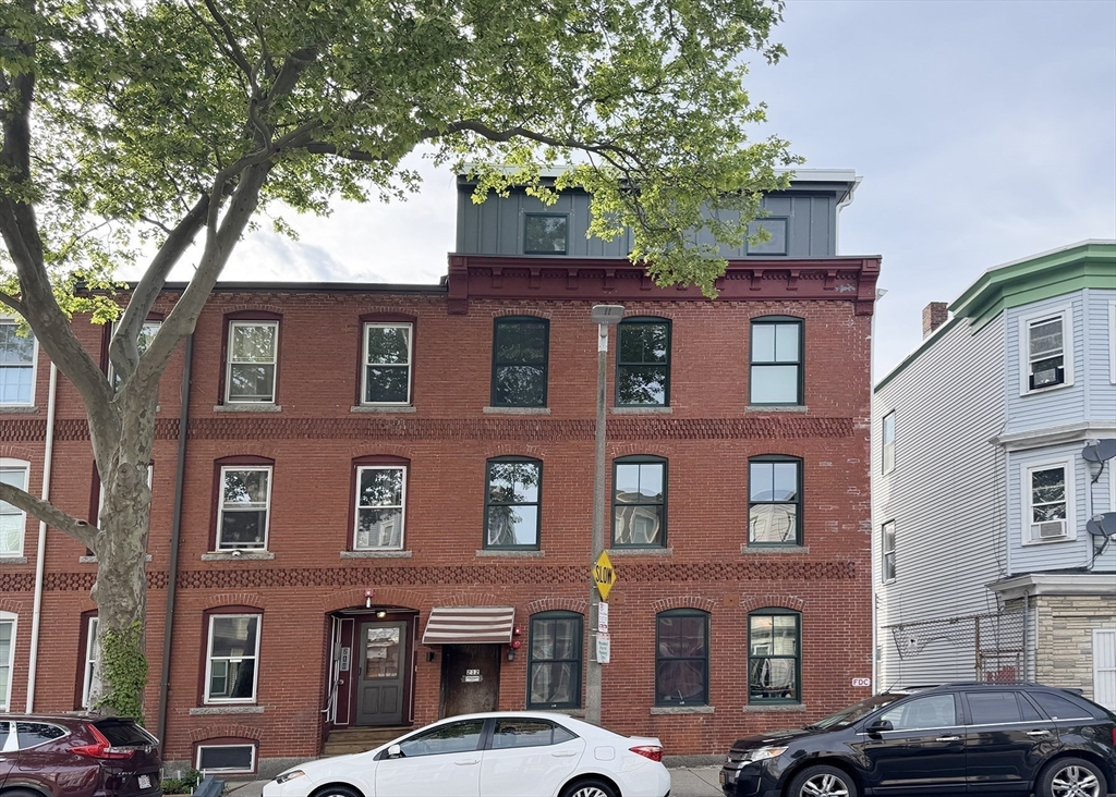 212 Chelsea Street, Unit 1 Boston, MA 02128 - Photo 15 of 24 a front view of a building with trees