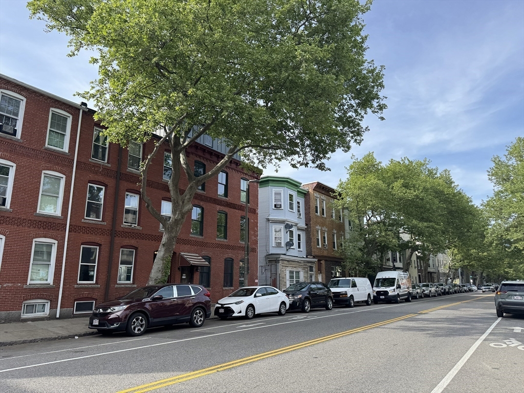 212 Chelsea Street, Unit 1 Boston, MA 02128 - Photo 16 of 24 a city street lined with buildings and cars