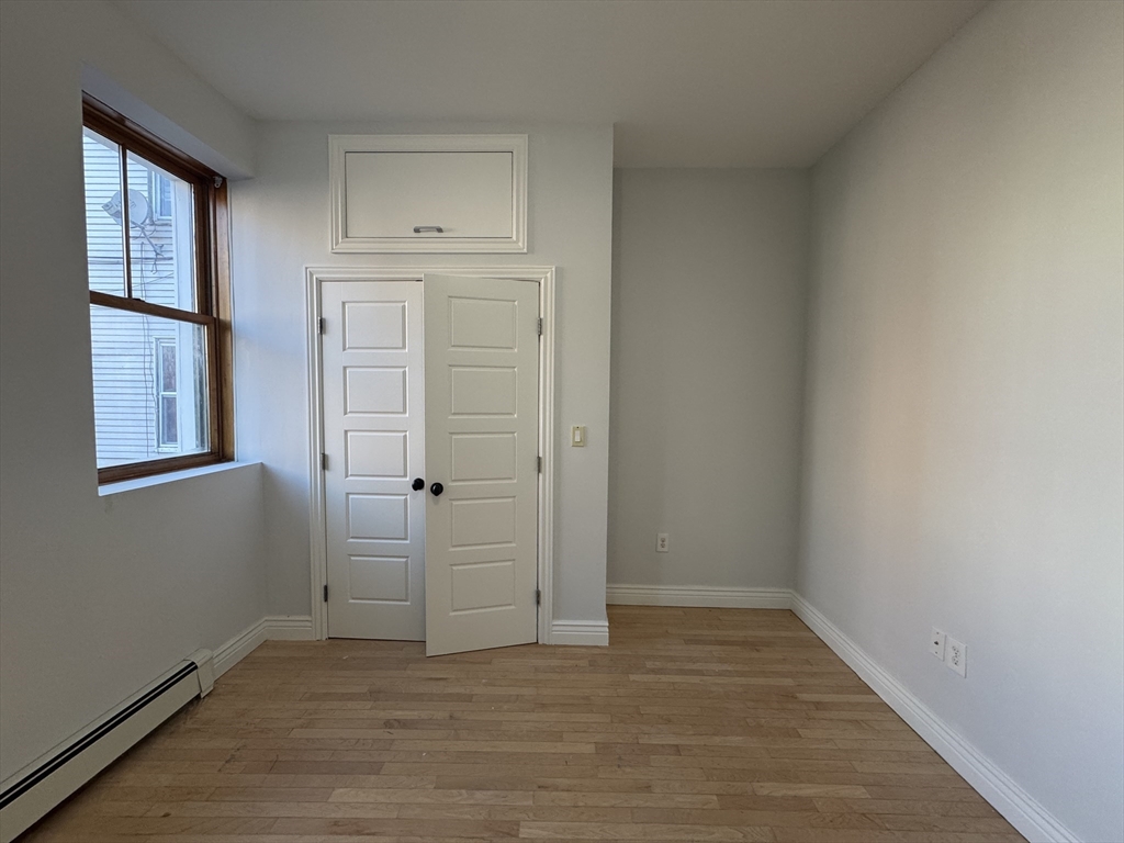 212 Chelsea Street, Unit 1 Boston, MA 02128 - Photo 5 of 24 an empty room with windows