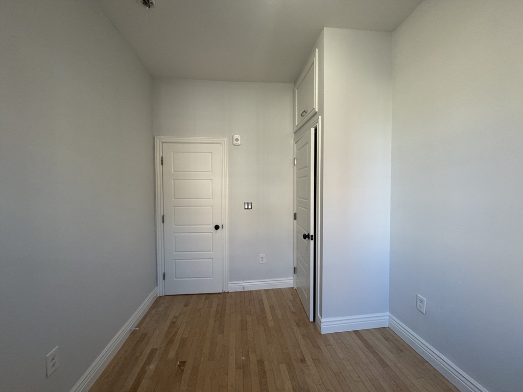 212 Chelsea Street, Unit 1 Boston, MA 02128 - Photo 8 of 24 a view of a room with wooden floor