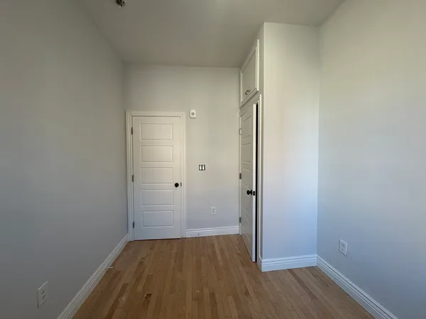 a view of a room with wooden floor