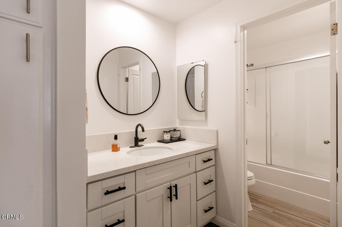 2940 North Verdugo Road, Unit 309 Glendale, CA 91208 - Photo 17 of 26 a bathroom with a double vanity sink and a mirror