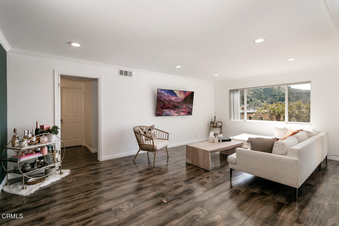 2940 North Verdugo Road, Unit 309 Glendale, CA 91208 - Photo 2 of 26 a living room with furniture and a wooden floor