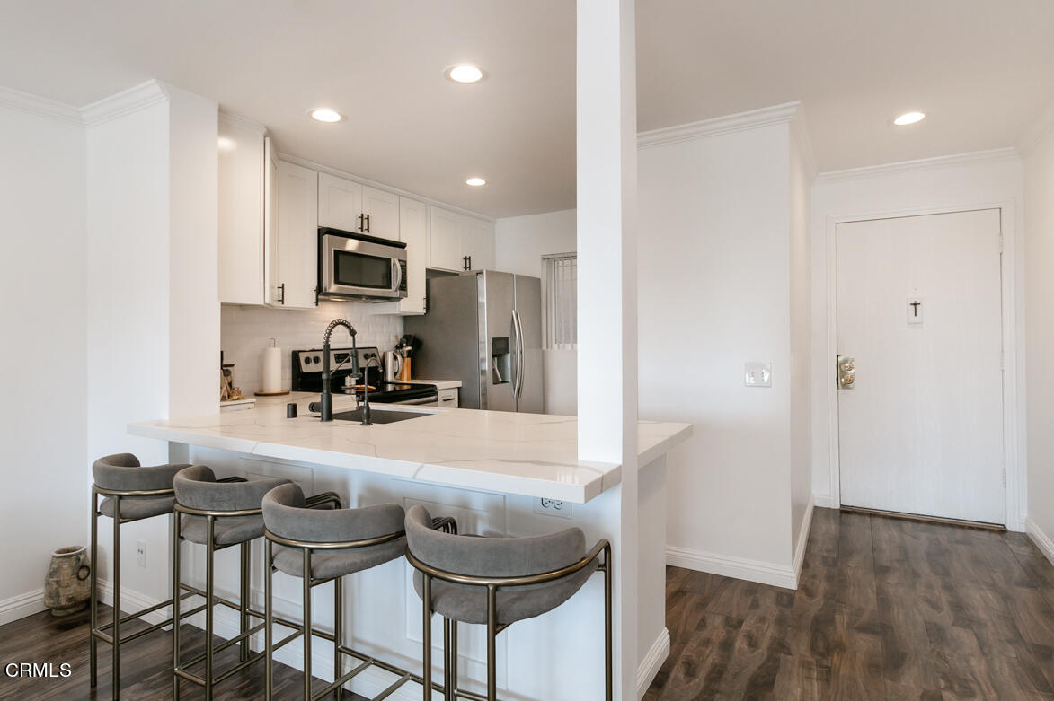 2940 North Verdugo Road, Unit 309 Glendale, CA 91208 - Photo 4 of 26 a kitchen with granite countertop white cabinets and stainless steel appliances