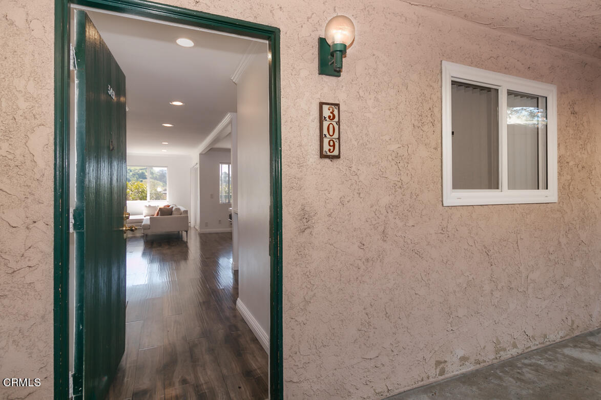 2940 North Verdugo Road, Unit 309 Glendale, CA 91208 - Photo 7 of 26 a view of a hallway with wooden floor windows and a living room