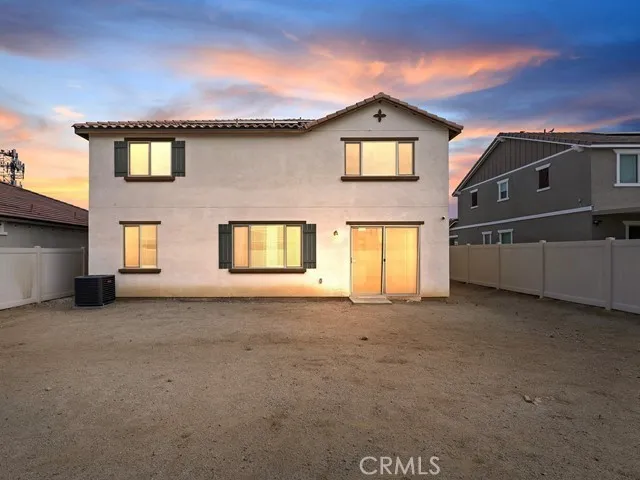 a view of an empty room with a window and fire place