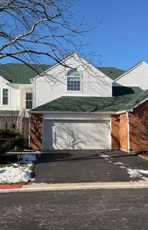a front view of a house with garage