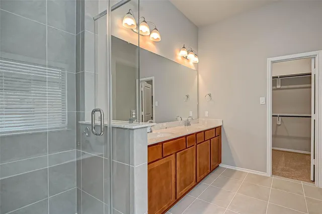a bathroom with a double vanity sink and a mirror