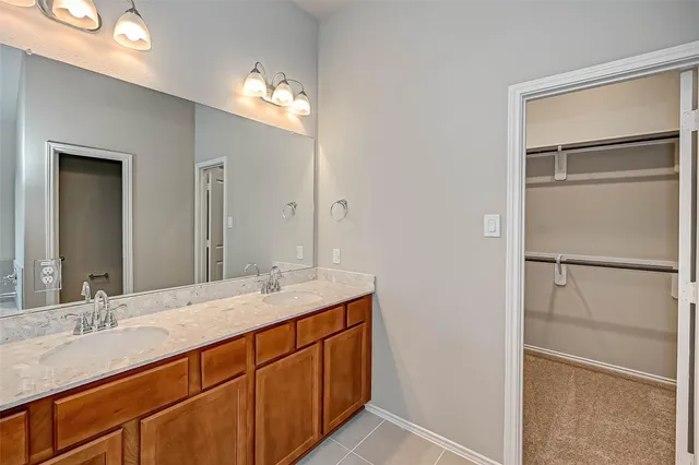 a bathroom with a double vanity sink and a mirror