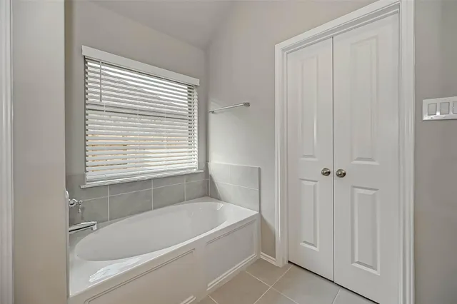 a white bath tub sitting next to a window