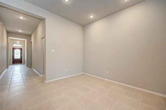 an empty room with closet and windows