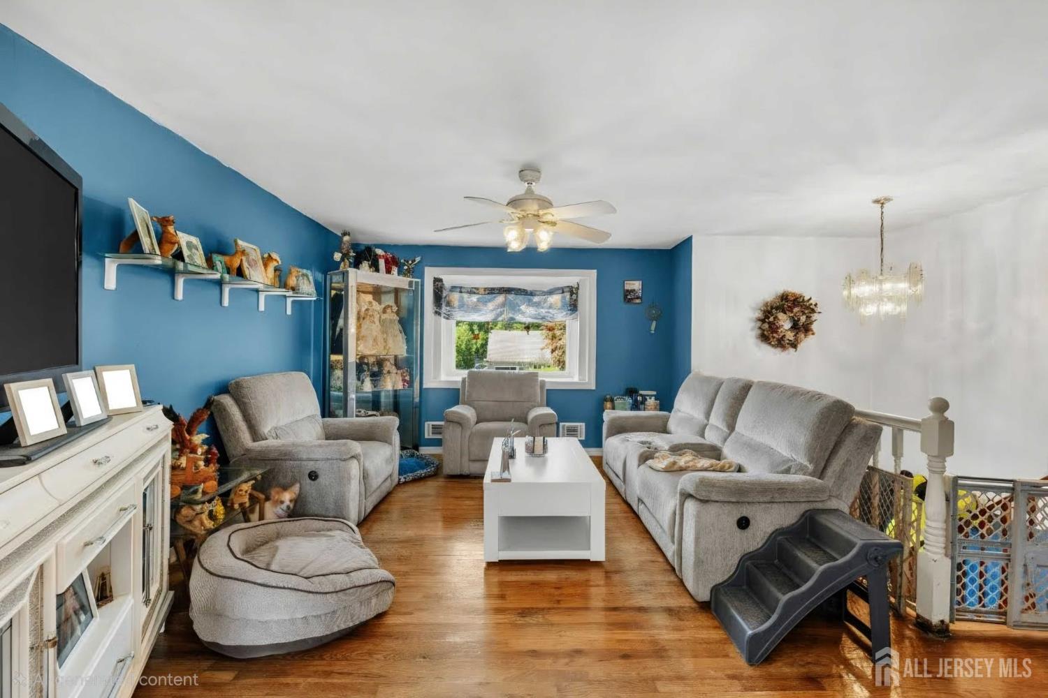 245 4th Street Dunellen, NJ 08812 - Photo 3 of 27 a living room with furniture and a chandelier