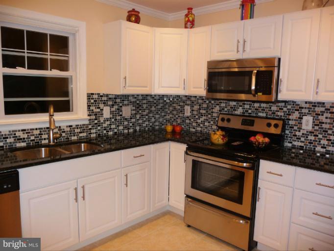 5709 Norton Road Alexandria, VA 22303 - Photo 25 of 30 Tiled Back Splash Adds Refinement to Kitchen