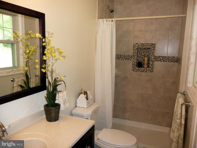 5709 Norton Road Alexandria, VA 22303 - Photo 6 of 30 Custom Tiling In Shower. Window Adds Brightness