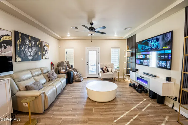 a living room with furniture a rug and a flat screen tv