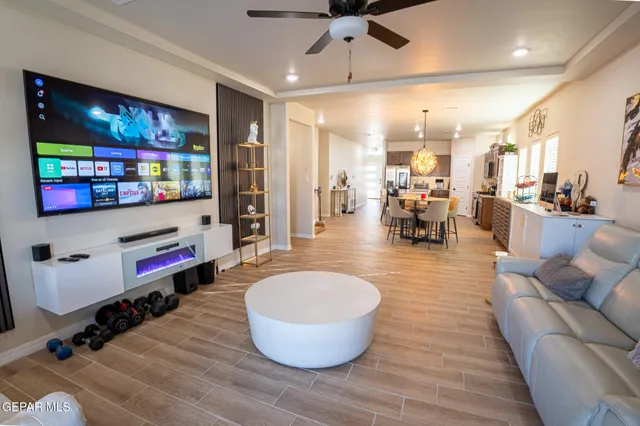 a room with lots of furniture and view of kitchen